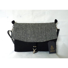 Load image into Gallery viewer, Black & herringbone Harris Tweed messenger bag with an adjustable black leather strap and a black lining with a zipped pocket