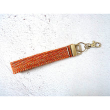 Load image into Gallery viewer, Harris Tweed wristlet kering with a clip - orange herringbone