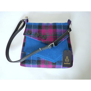 Bright blue and pink check harris tweed shoulder bag with an adjustable black leather strap and a bright blue lining with a zipped pocket