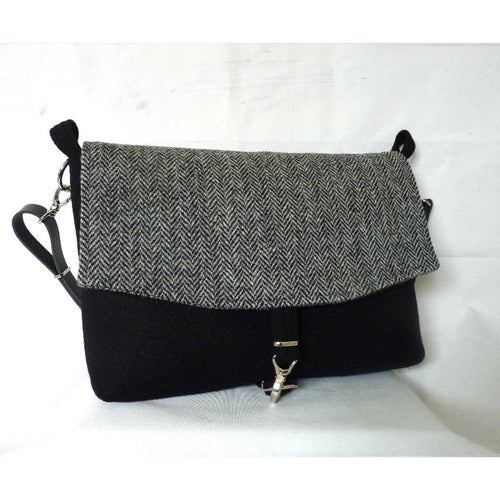Harris Tweed Wernside laptop bag in plain black with a grey herringbone flap and adjustable leather strap