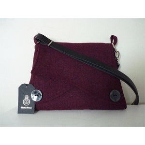 Burgundy Harris Tweed shoulder bag with an adjustable black leather strap and a black lining with a zipped pocket