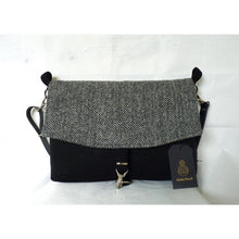 Load image into Gallery viewer, Black &amp; herringbone Harris Tweed messenger bag with an adjustable black leather strap and a black lining with a zipped pocket