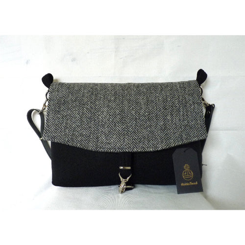 Black & herringbone Harris Tweed messenger bag with an adjustable black leather strap and a black lining with a zipped pocket