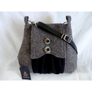 Grey , lemon & black harris tweed poacher bag with an adjustable black leather strap and a black lining with a zipped pocket