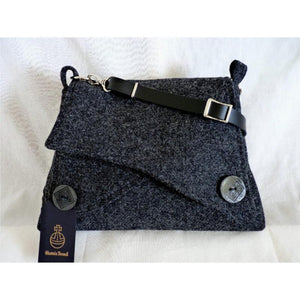 Dark grey Harris Tweed shoulder bag with an adjustable black leather strap and a black lining with a zipped pocket